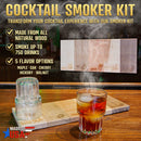 Cocktail smoker kit with a glass of cocktail on a wooden surface, featuring smoke and product packaging.