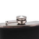 Close-up of a black flask with a silver cap on a white background