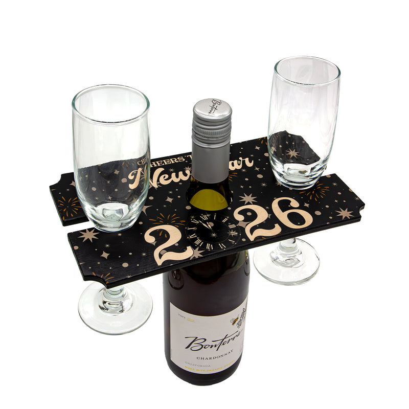 Wine bottle and glasses on a decorative stand with 'New Year's Eve' theme