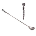 A long metal spoon with a twisted handle and a decorative cobra head handle, shown on a plain white background with a smaller inset view of the top detail.