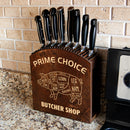 Wooden knife block with engraved butcher shop design and knives on a kitchen counter.