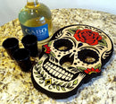Decorative skull-shaped tray with shot glasses and a bottle of Cabo Wabo tequila on a granite surface.