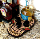 Skull-shaped bottle holder with liquor bottles on a granite countertop