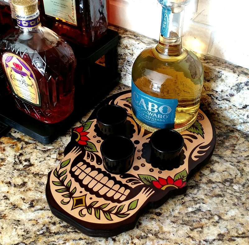 Skull-shaped bottle holder with liquor bottles on a granite countertop