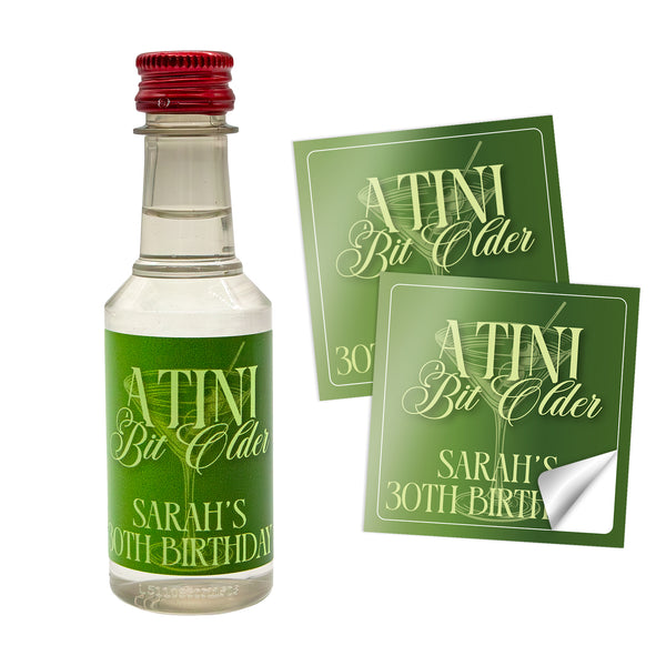 Miniature bottle of alcohol with personalized labels on a white background