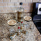 Bottle with custom label with two glasses of a dark beverage on a countertop and mini bottles with matching label. 